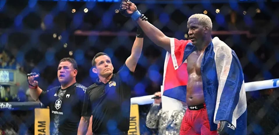 Fighter celebrating victory with flag in octagon