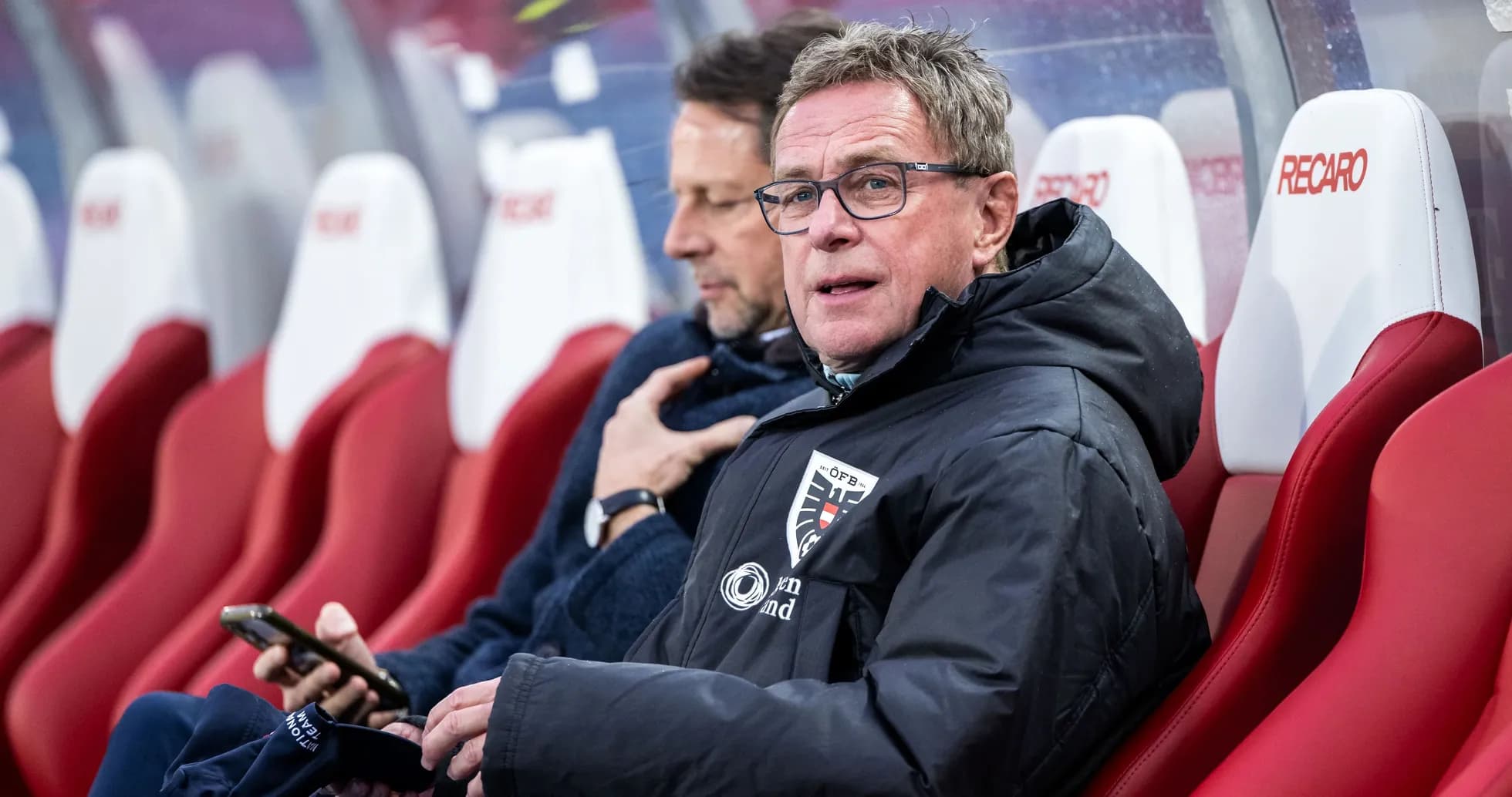 Entraîneur assis sur le banc de touche pendant le match