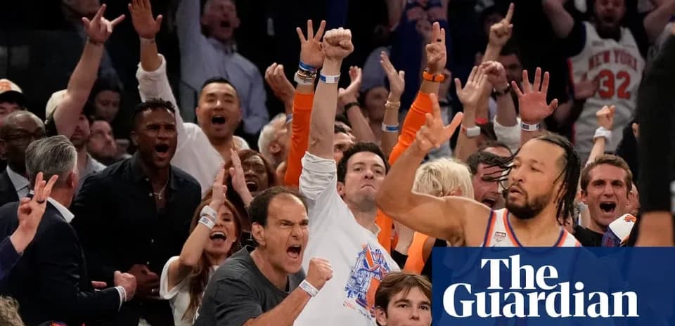 Spectators cheering enthusiastically at a basketball game