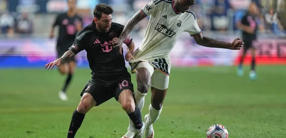 Messi attempting to gain possession from opposing player