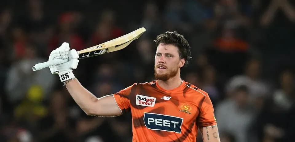 Joueur de cricket levant sa batte en signe de célébration