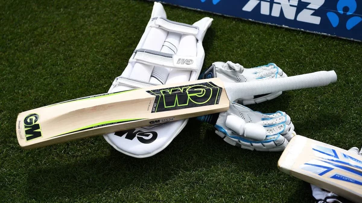 Bat and cricket gear on grass surface