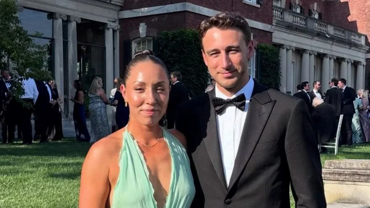Couple posing in formal attire at outdoor event