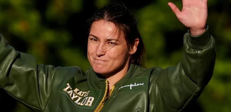 Athlete saluting while wearing a green jacket