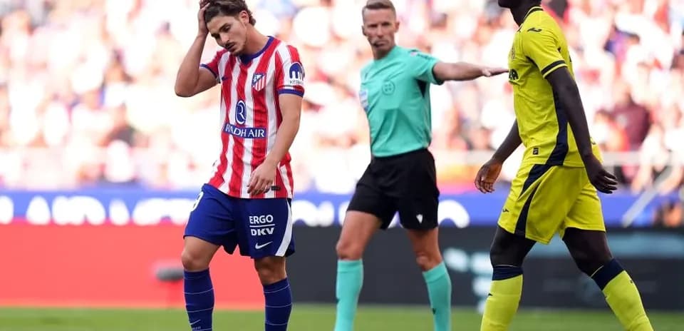 Joueur d'Atlético se tenant la tête après une faute