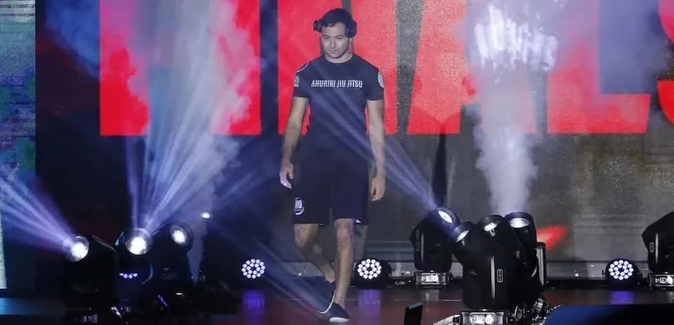 Athlete entering arena during finals with smoke and lights