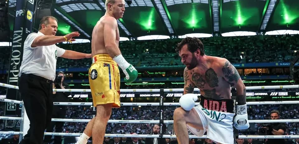 Boxers in ring with referee during match