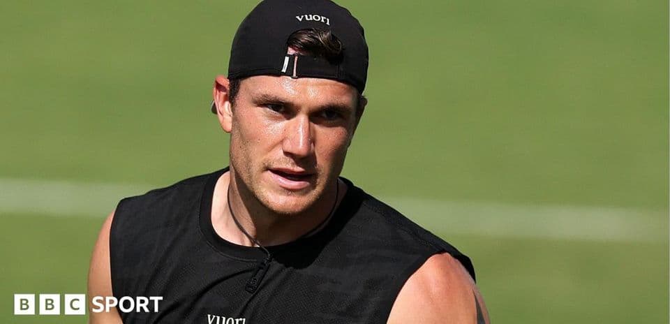 Athlete training on field wearing black tank top
