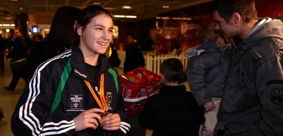 Athlete with medal chatting in an airport