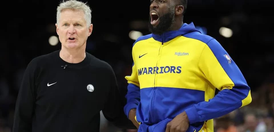 Entraîneur parlant avec joueur des Warriors sur le terrain