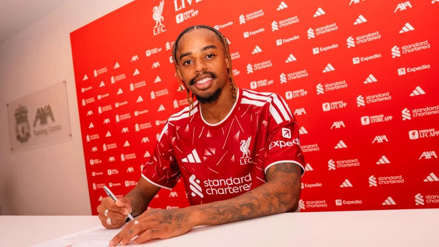 Joueur de Liverpool signant un contrat à la table