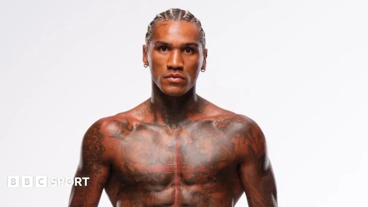 Athlete posing with visible tattoos and braided hair