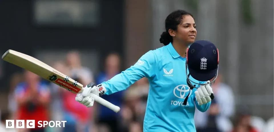 Joueuse de cricket levant sa batte après un score