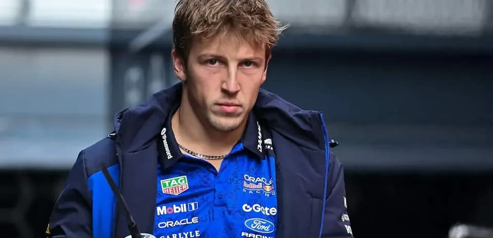 Pilote de F1 portant une veste d'équipe dans le paddock
