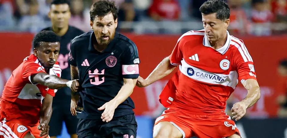 Messi dribbling past defenders during soccer match
