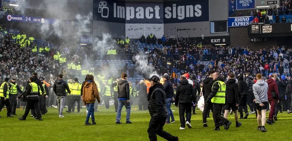 Supporters on the pitch after the match ends