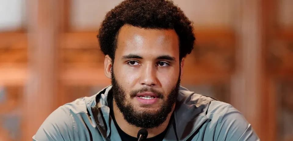 Athlete speaking at a press conference podium