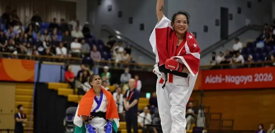 Athlete celebrating victory with raised hand and flag