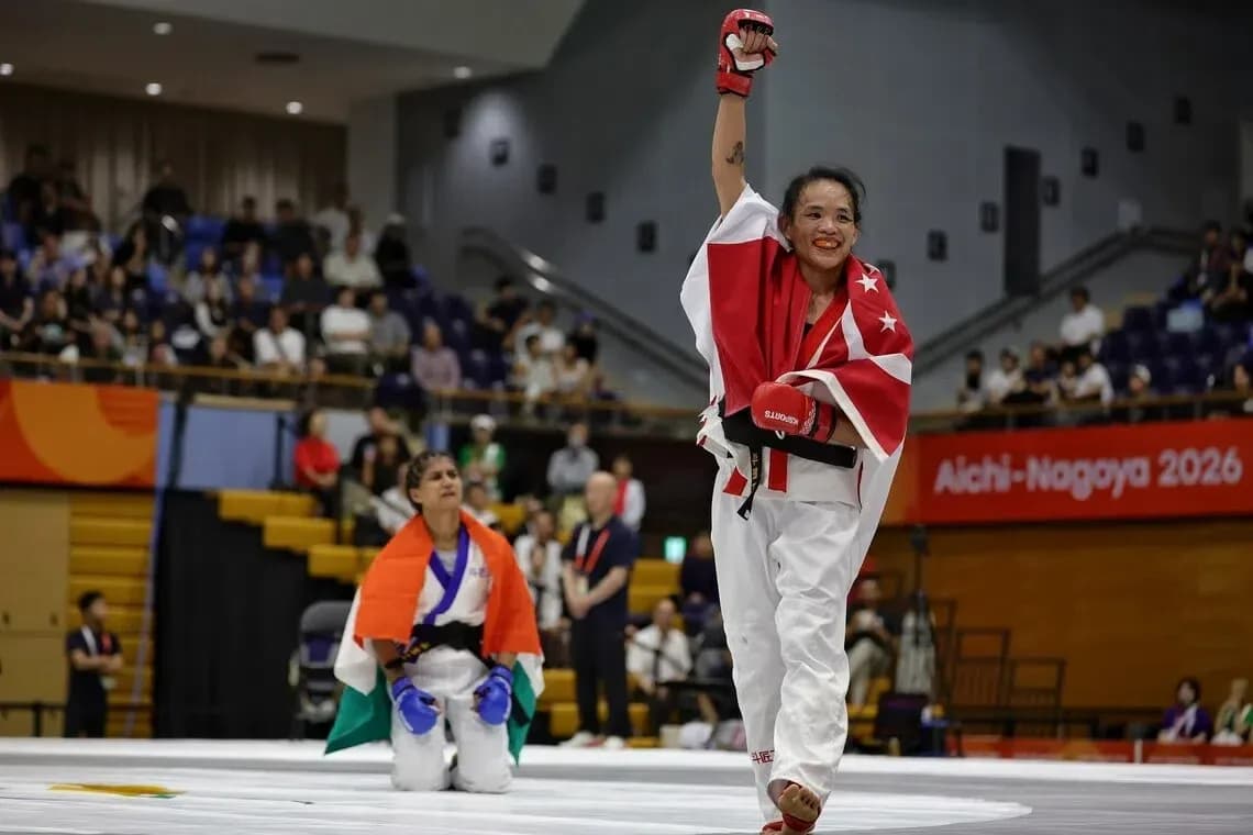 Athlete celebrating victory with raised hand and flag