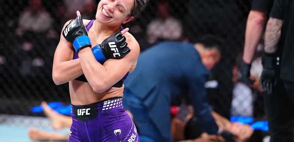 Fighter celebrating victory after match in octagon