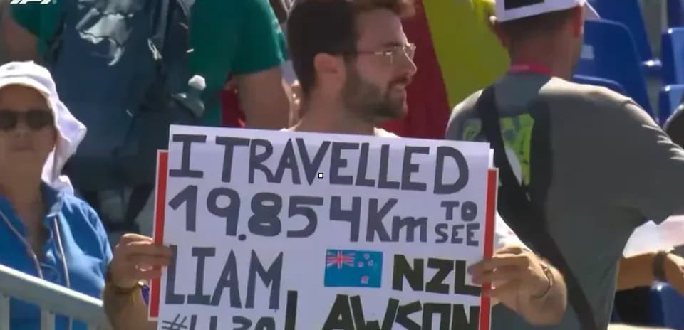 Spectator holding sign for Liam Lawson at event