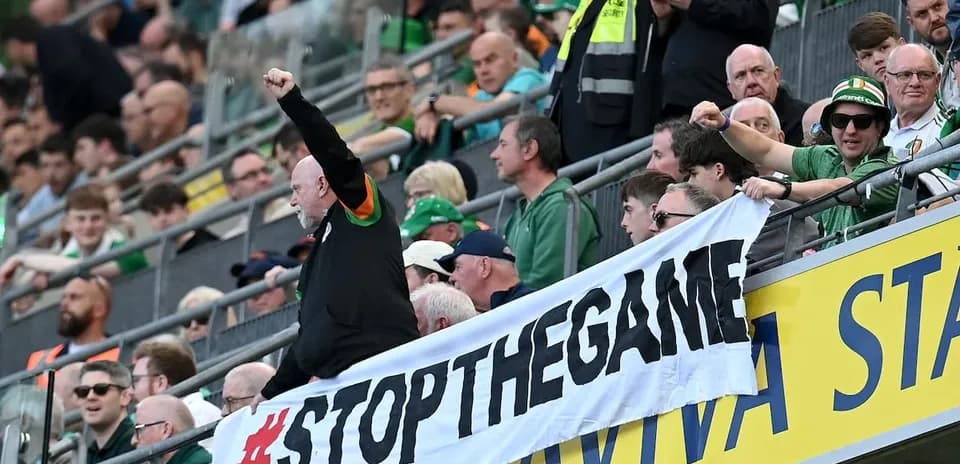 Supporters holding a banner in the stands