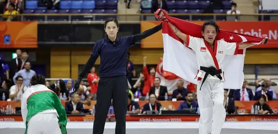 Athlete celebrating victory with national flag in arena