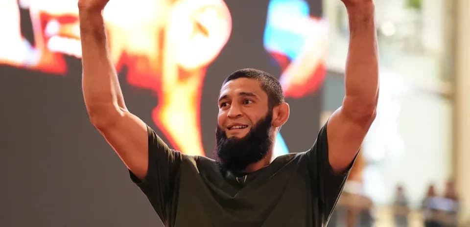 Fighter celebrating with raised arms at event