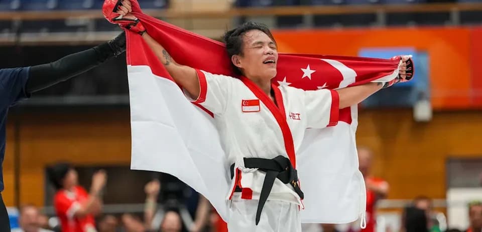 Athlete celebrating with Singapore flag after victory
