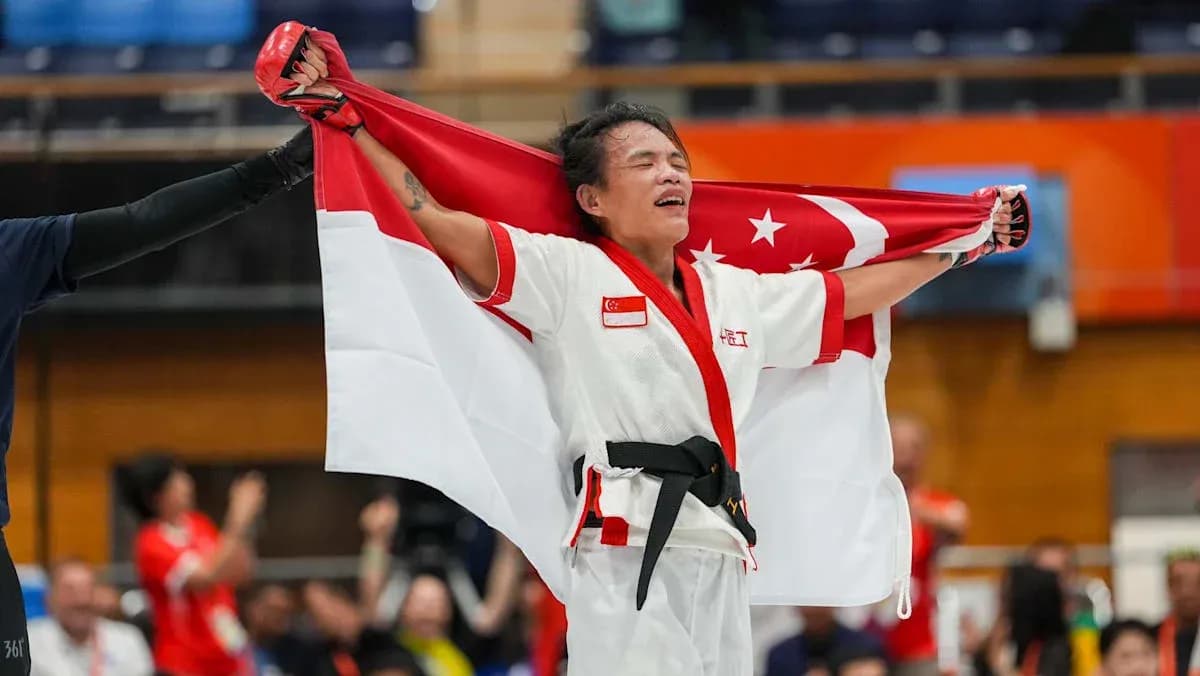 Athlete celebrating with Singapore flag after victory