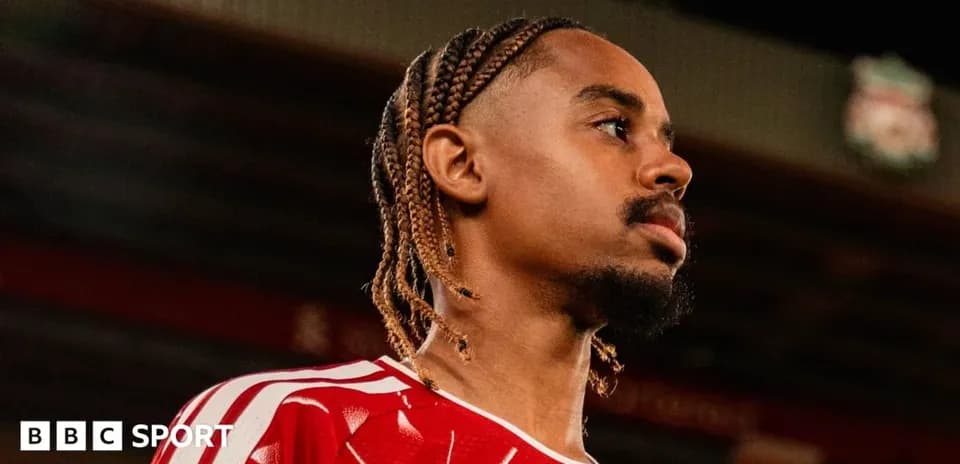 Joueur en maillot rouge regardant au loin