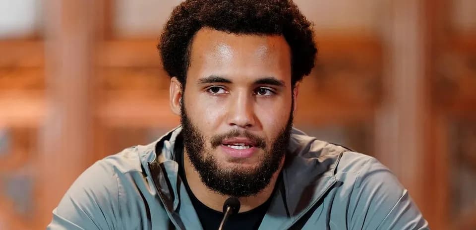 Athlete speaking at press conference with microphone