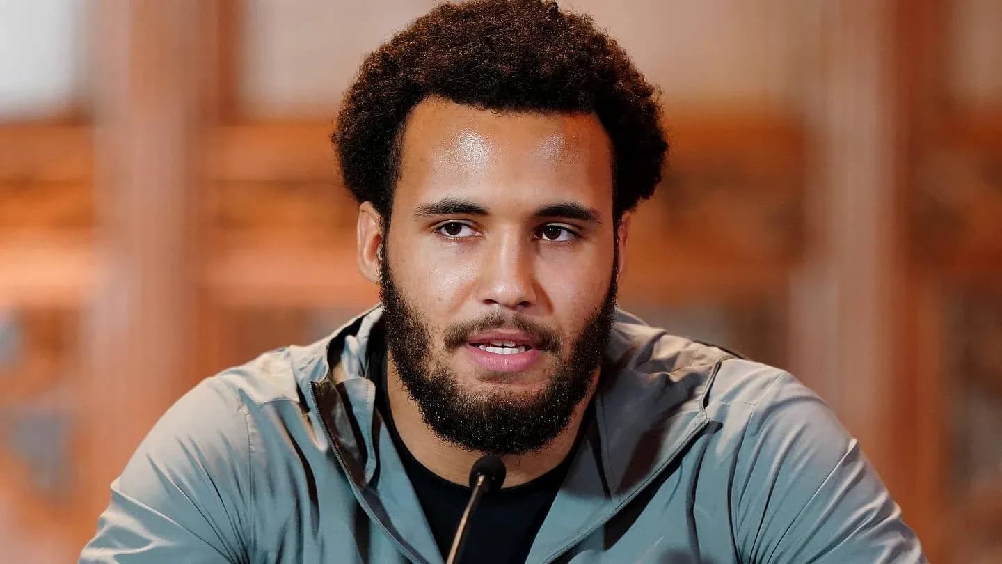 Athlete speaking at press conference with microphone