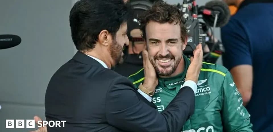 Fernando Alonso smiling with teammate after race
