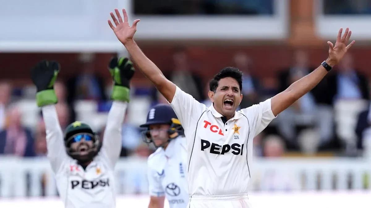 Joueur de cricket levant les bras en signe de célébration