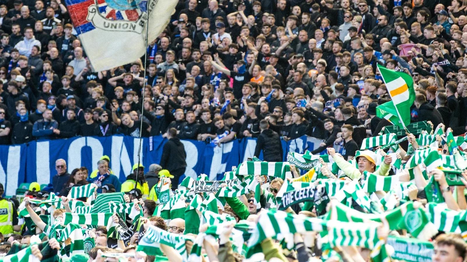Supporters waving scarves in a football stadium