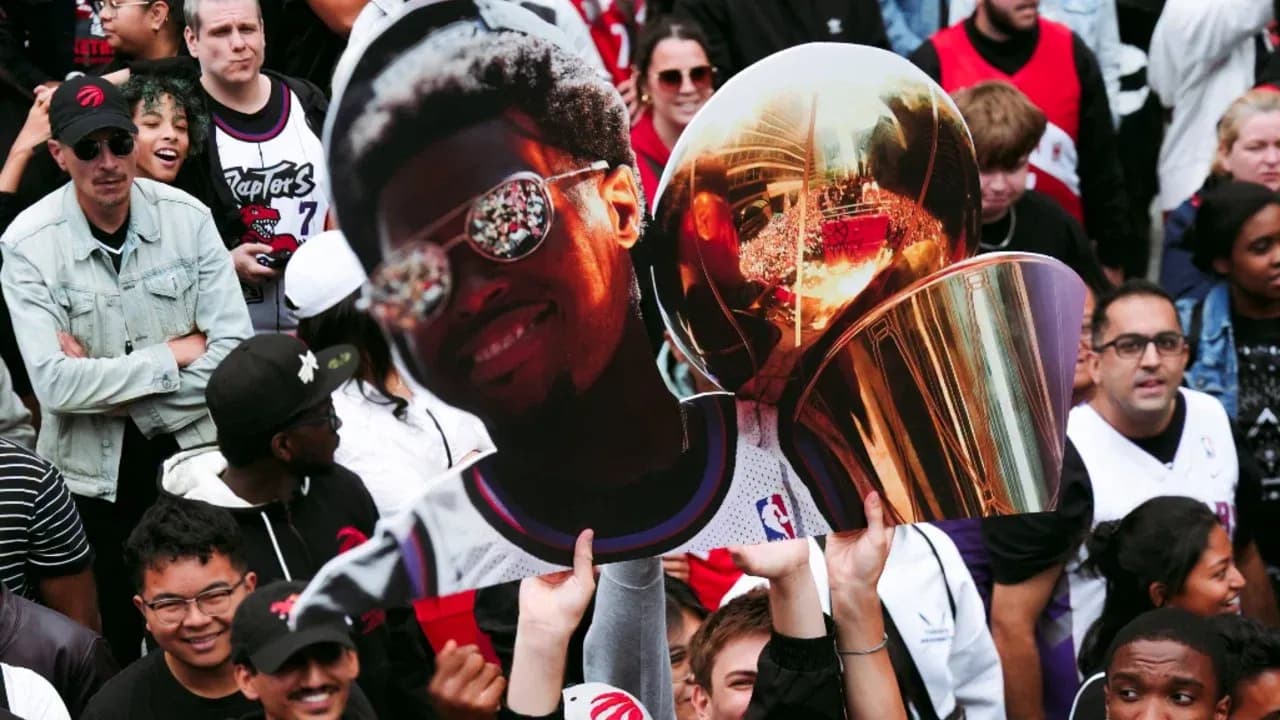 Supporters holding a large cutout and trophy Supporters holding a large cutout and trophy