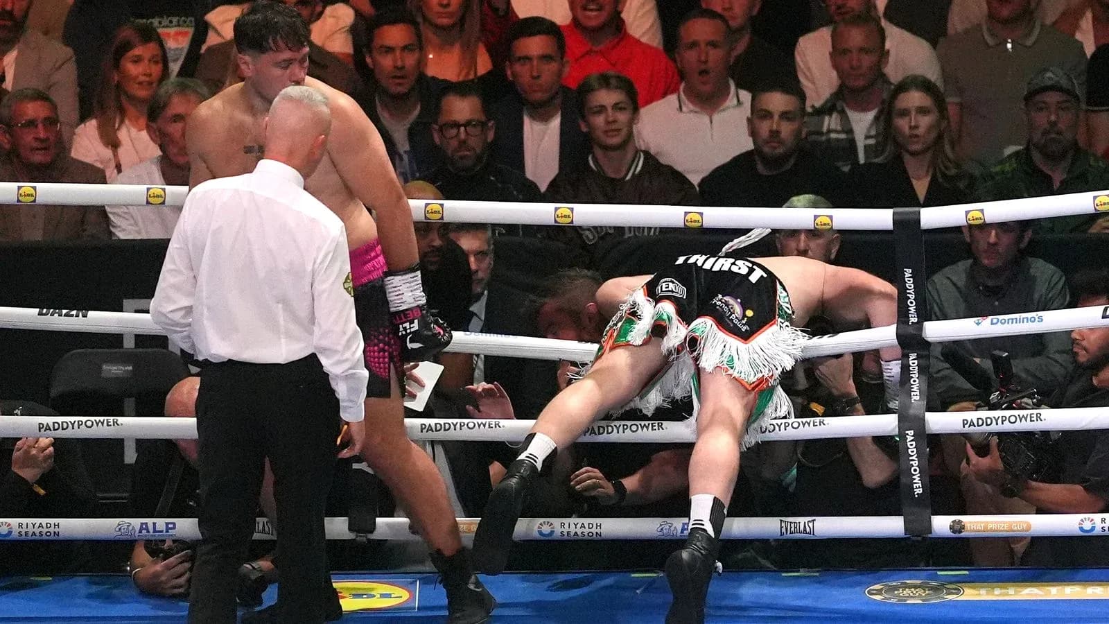 Boxer falling against the ropes during a match Boxer falling against the ropes during a match
