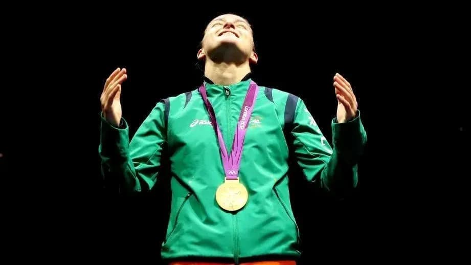 Athlete celebrating with gold medal on podium Athlete celebrating with gold medal on podium