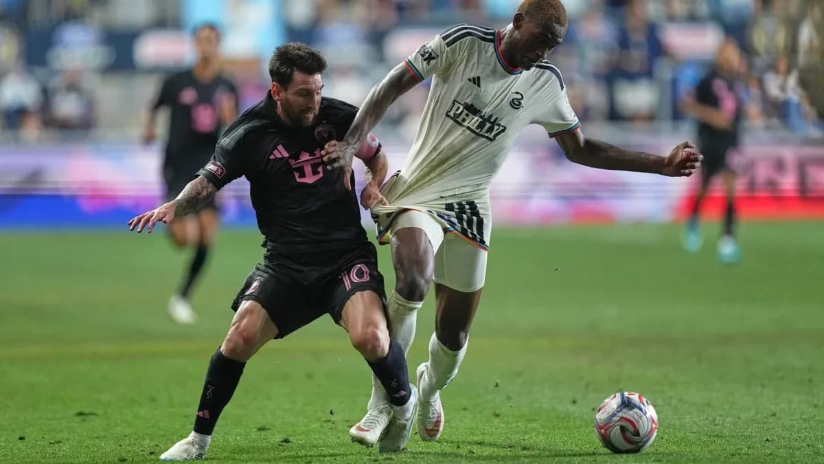 Messi attempting to gain possession from opposing player Messi attempting to gain possession from opposing player
