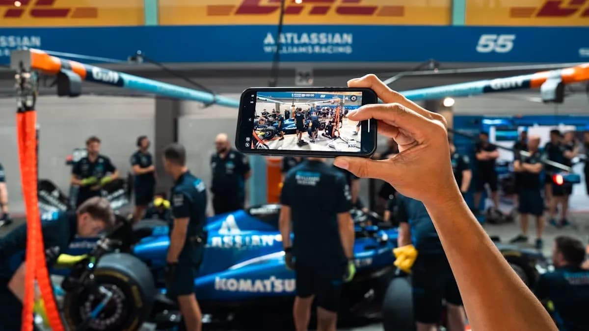 Person filming Williams Racing team in garage Person filming Williams Racing team in garage