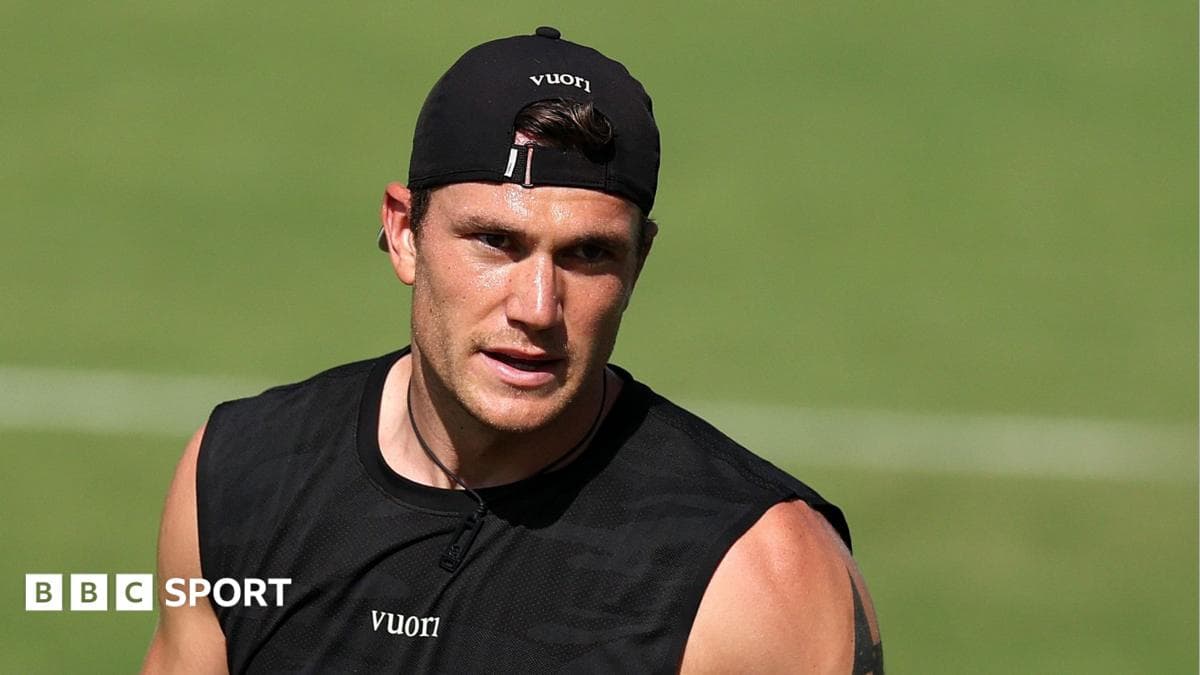 Athlete training on field wearing black tank top Athlete training on field wearing black tank top
