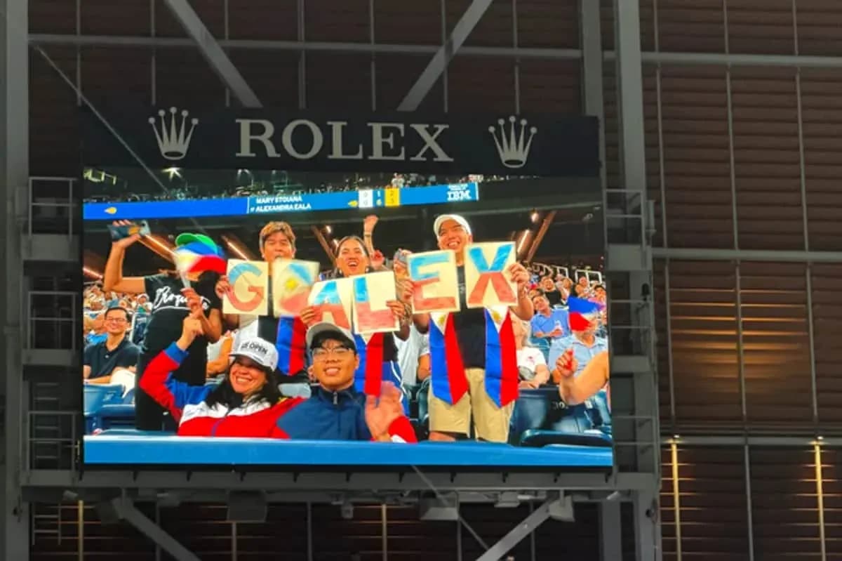 Supporters holding 'GO ALEX' signs at event Supporters holding 'GO ALEX' signs at event