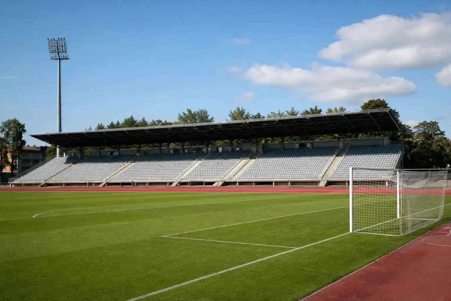 Stade de football avec tribunes et terrain vert Stade de football avec tribunes et terrain vert