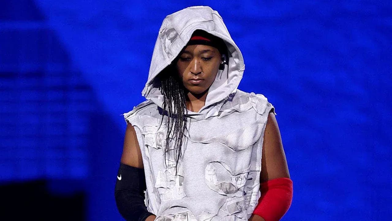 Athlete wearing a hooded outfit on stage Athlete wearing a hooded outfit on stage