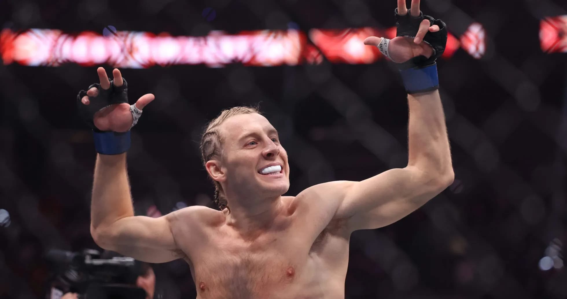 Fighter celebrating victory in the octagon Fighter celebrating victory in the octagon