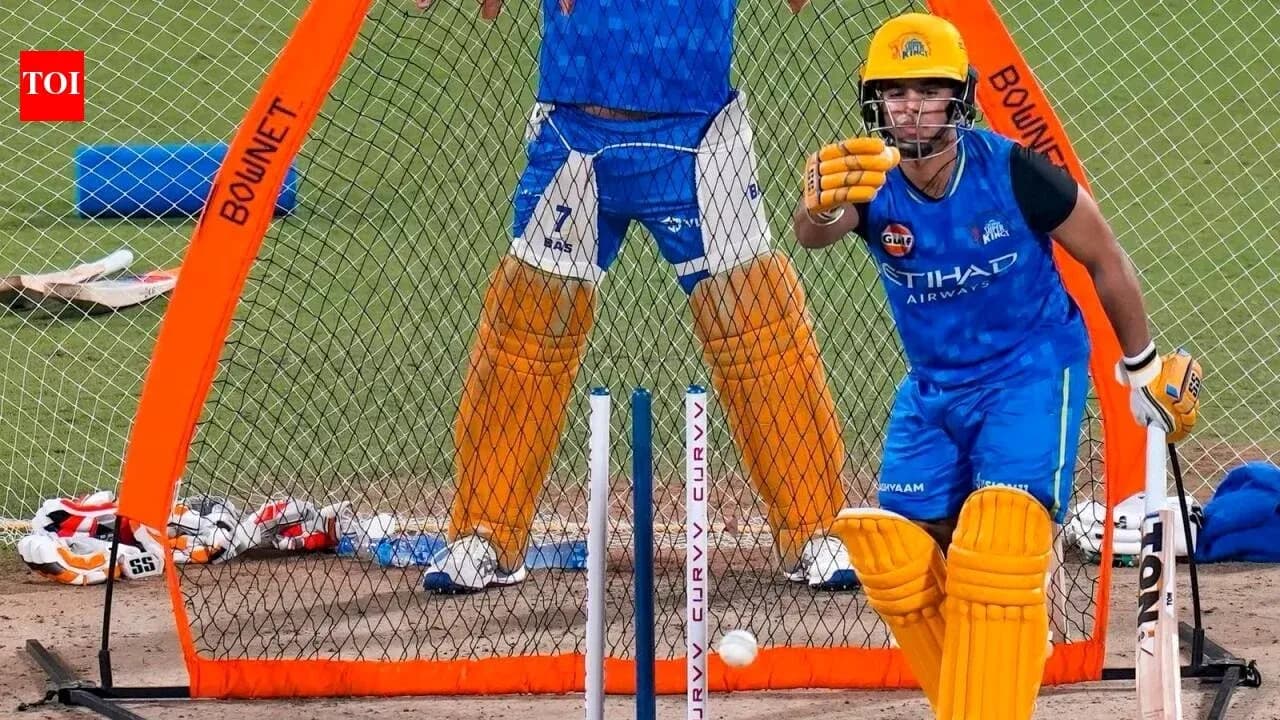 Batsman practicing in nets with wicketkeeper behind Batsman practicing in nets with wicketkeeper behind