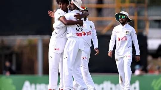 Joueurs de cricket célébrant une prise sur le terrain Joueurs de cricket célébrant une prise sur le terrain