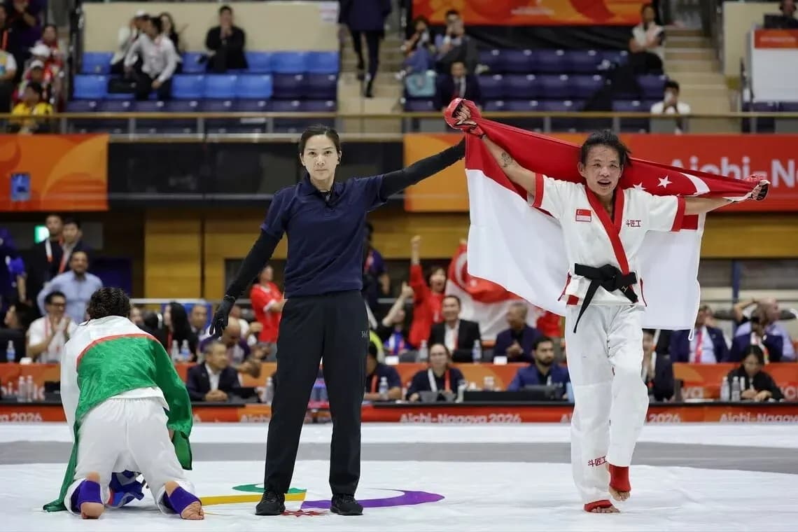 Athlete celebrating victory with national flag in arena Athlete celebrating victory with national flag in arena
